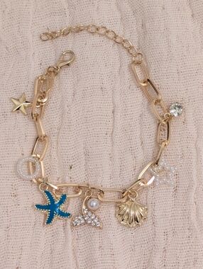 Gold-Tone Sea Charm Bracelet with Blue Starfish and Crystal Accents